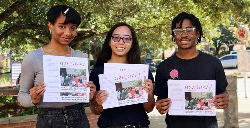 With print editions of The Vanguard student newspaper are, 从左, 布兰登·克拉克, managing editor; Stephanie Huynh, editor-in-chief; and Iman Thibodeaux, 作者的贡献.